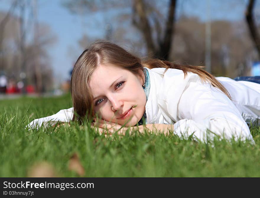 Young woman alone relaxing in spring park. Young woman alone relaxing in spring park