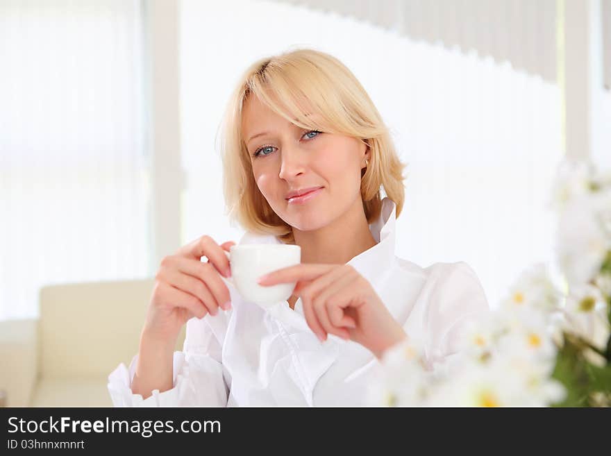 Portrait of young lady with a cup