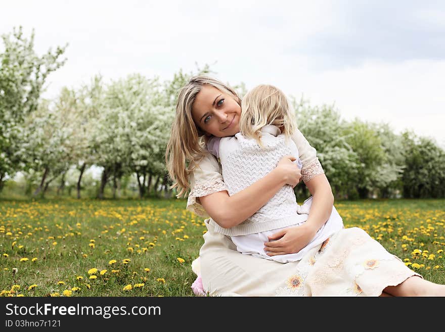 Happy girl and her mother in the spring park. Happy girl and her mother in the spring park