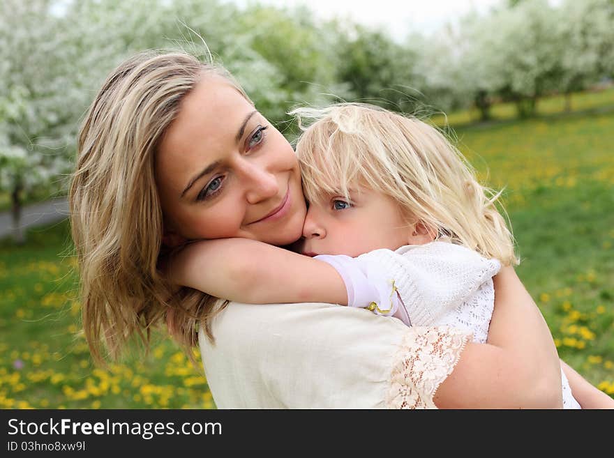 Happy girl and her mother in the spring park. Happy girl and her mother in the spring park