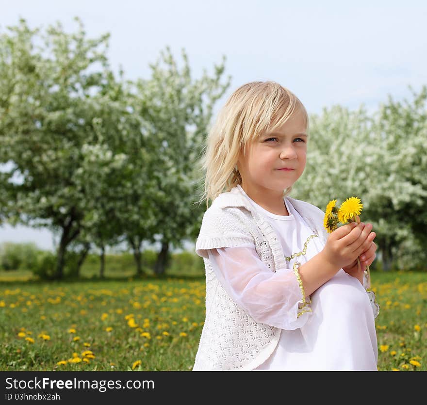 Little girl in white clothes in spring park. Little girl in white clothes in spring park