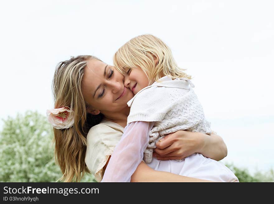 Happy girl and her mother in the spring park. Happy girl and her mother in the spring park