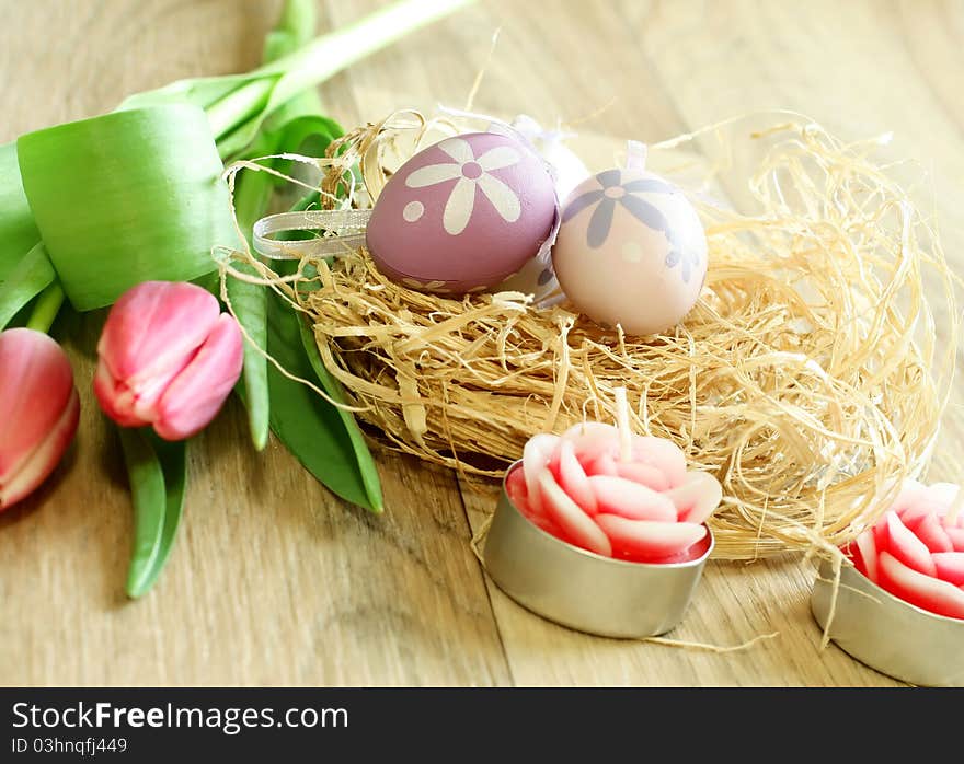 Easter Eggs, Tulips And Candles On Wooden