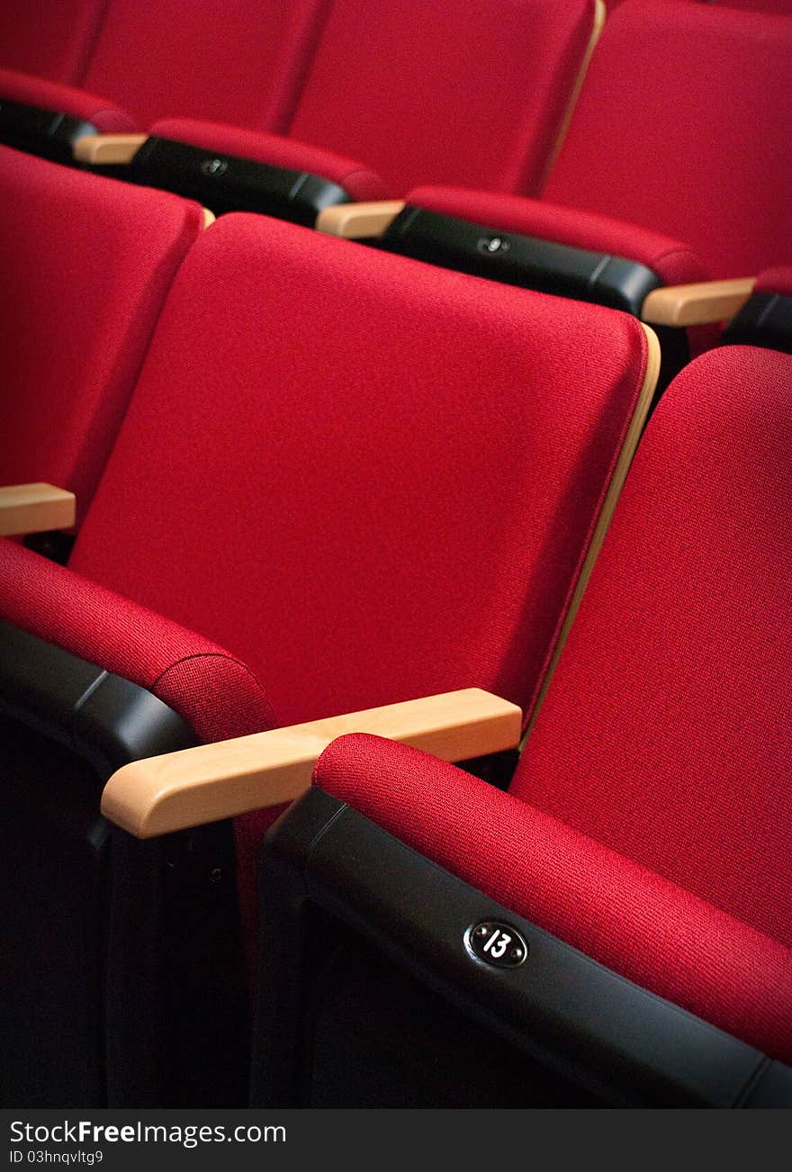 Empty red bench number thirteen of the theater. Empty red bench number thirteen of the theater