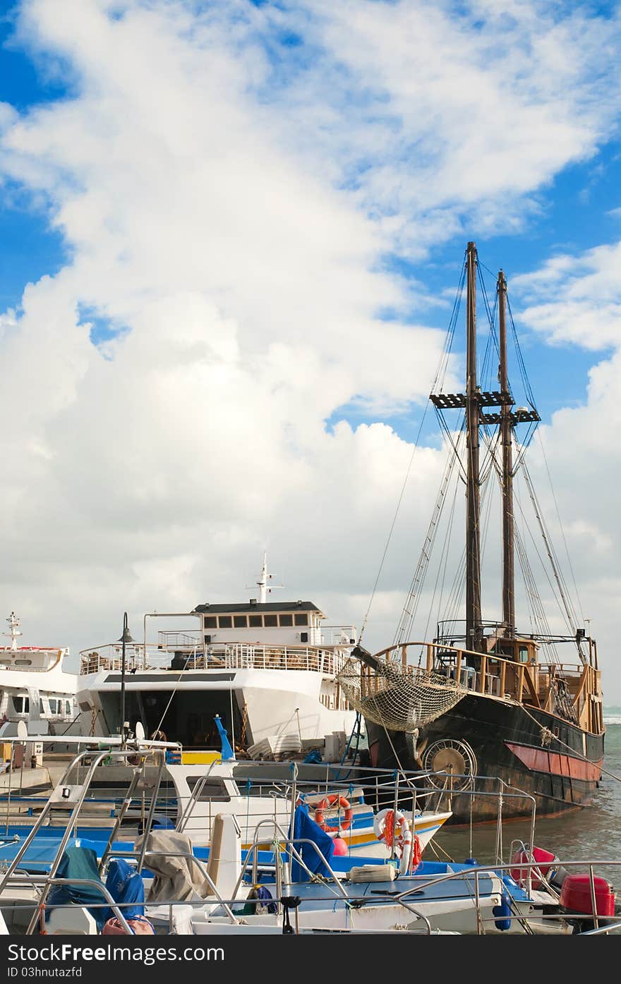 Yachts and fishing boats at pier