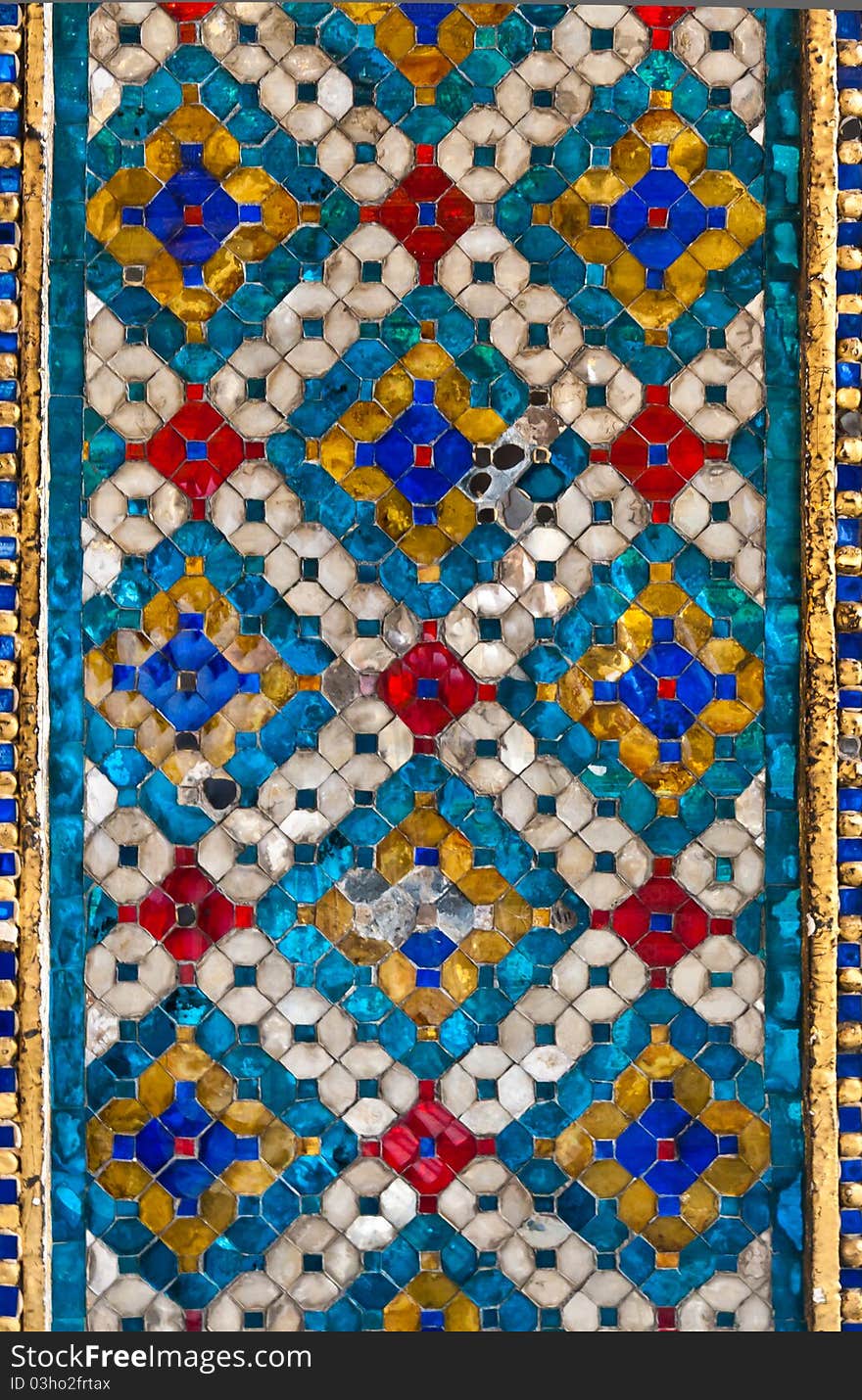 Thai pattern tile wall with blue and tlited white