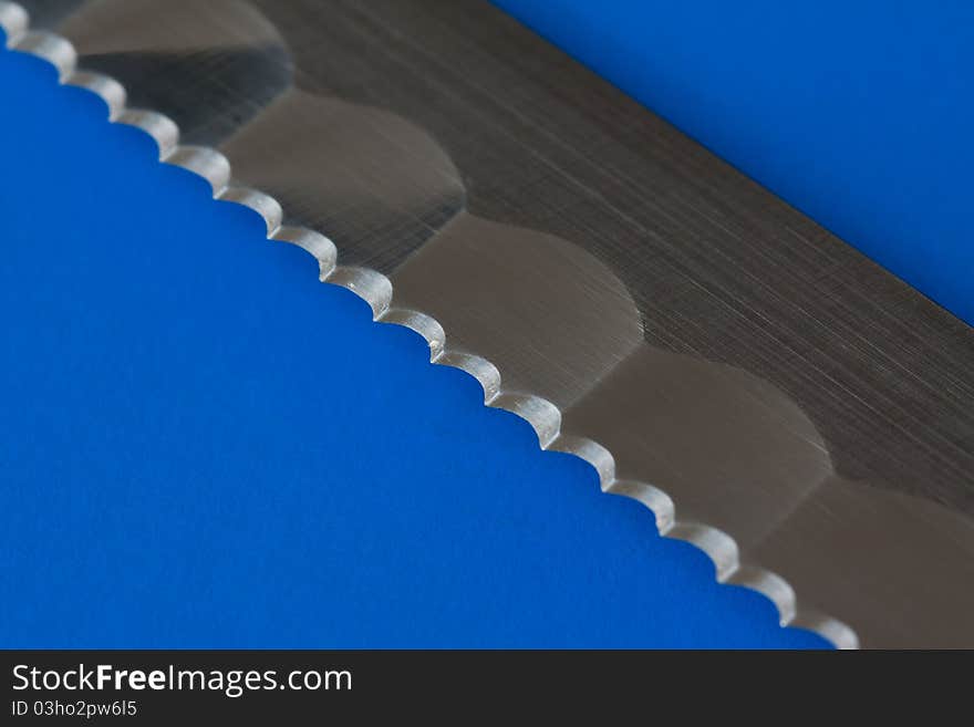 Knfe blade detatil in blue background. Knfe blade detatil in blue background