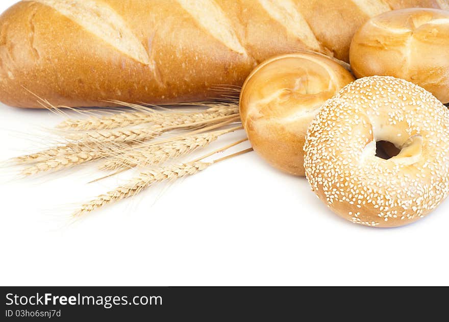 French baguette and bagels on white background