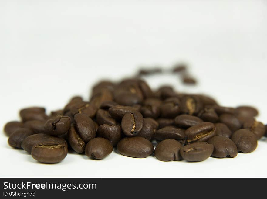 Toasted coffee beans, isolated background.