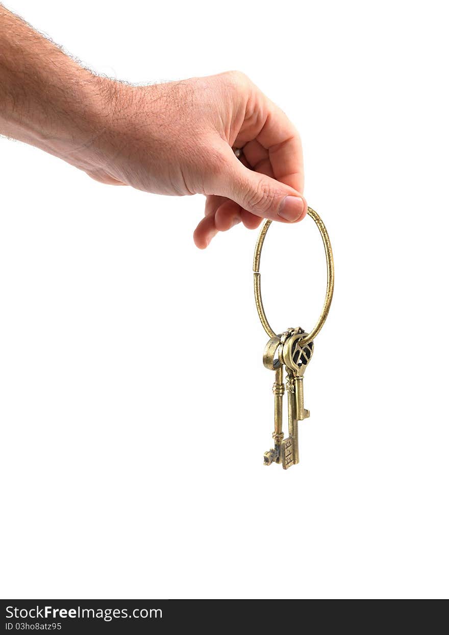 A vintage brass key isolated against a white background. A vintage brass key isolated against a white background