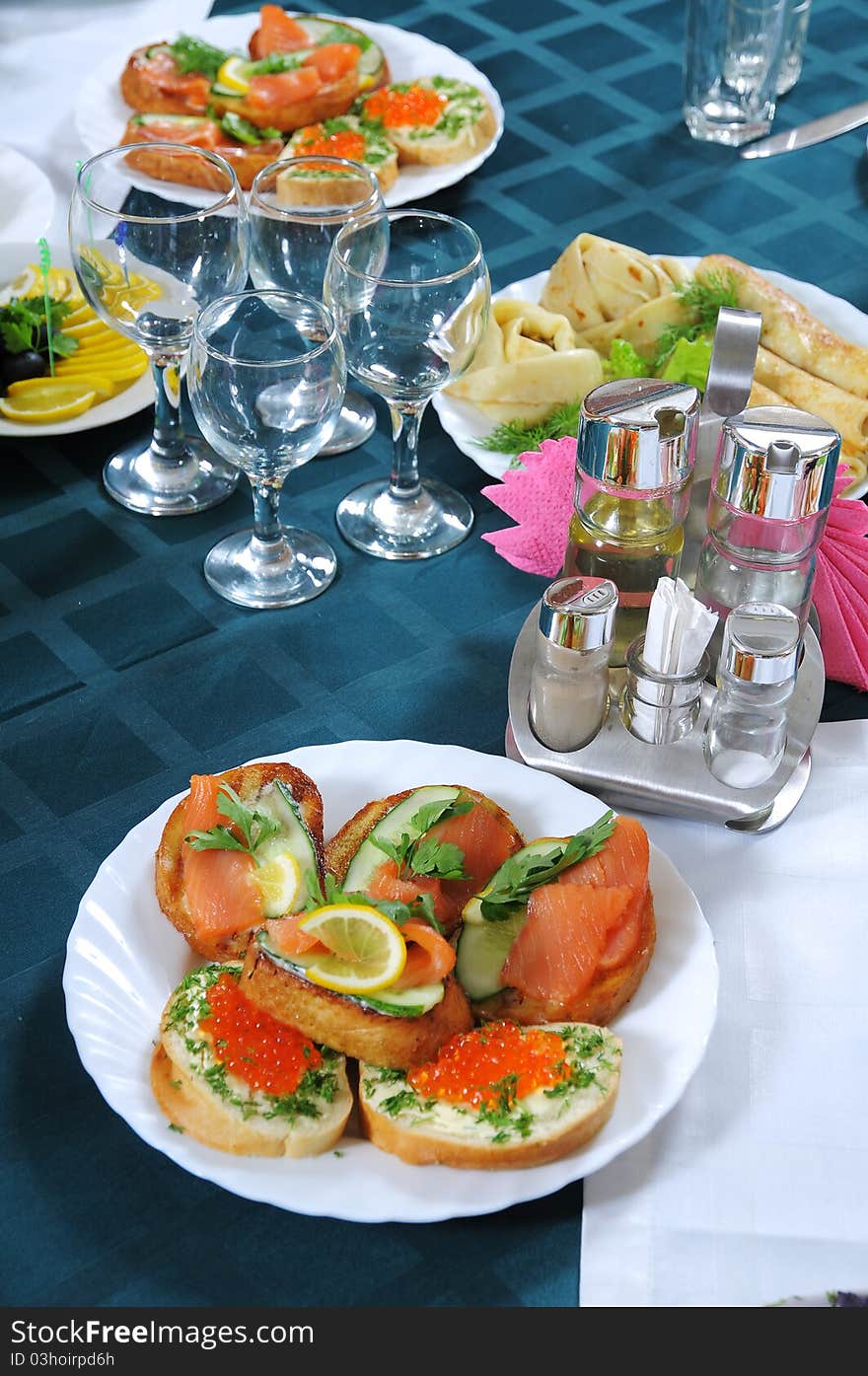 Tasty sandwiches with red caviar and a fillet of a salty salmon.