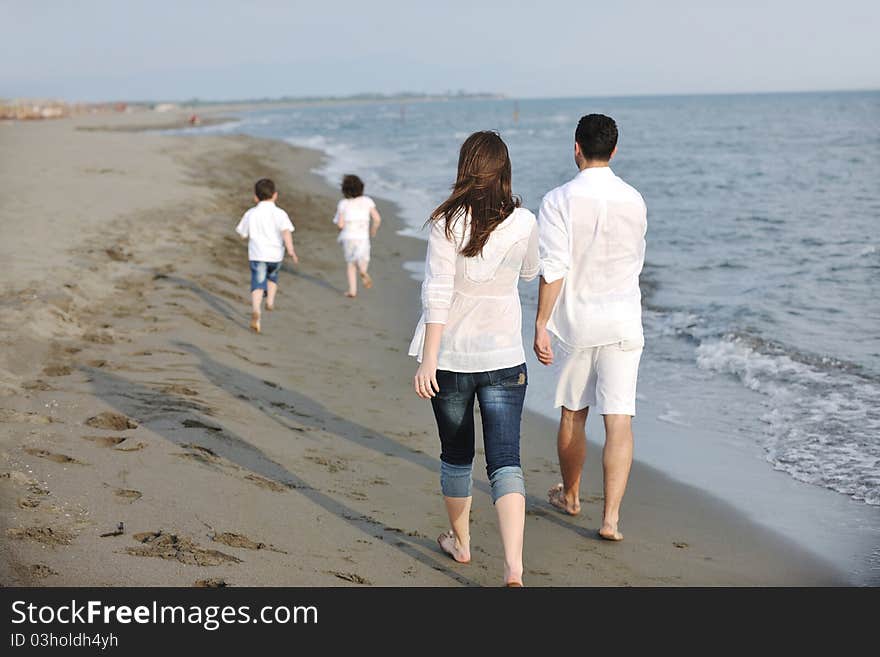 Happy young family have fun on beach