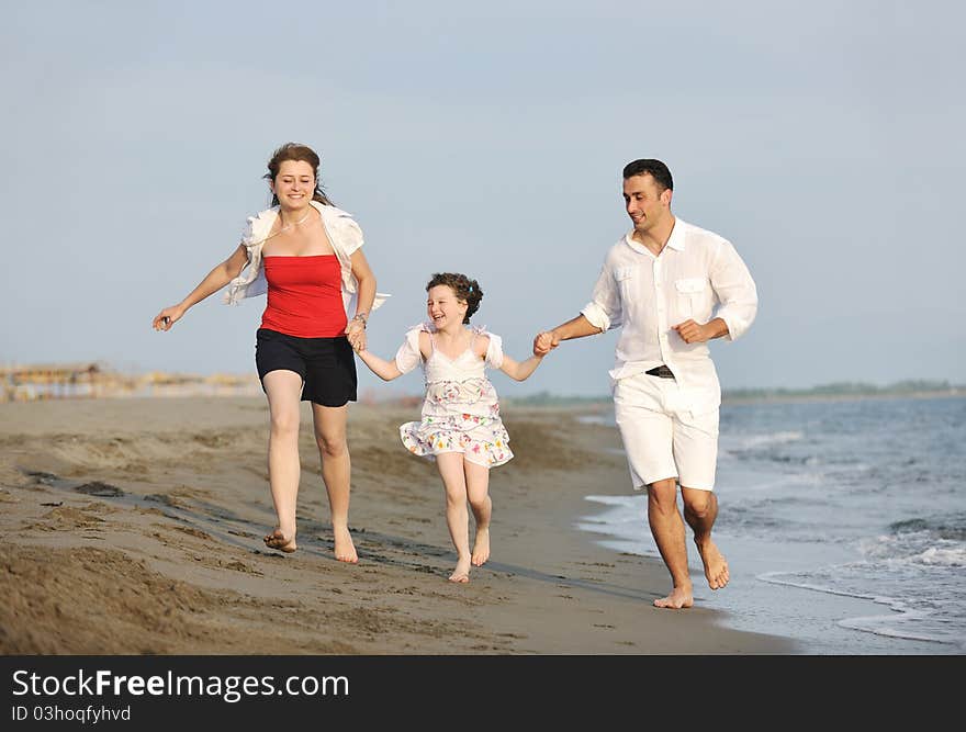 Happy young family have fun on beach