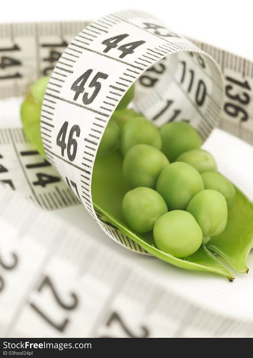 Peas in the shell with measuring tape. Peas in the shell with measuring tape