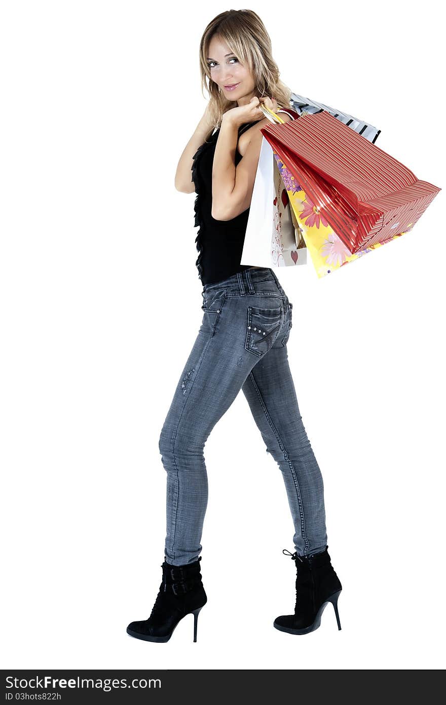 blond woman with shopping bags smiling happily. blond woman with shopping bags smiling happily