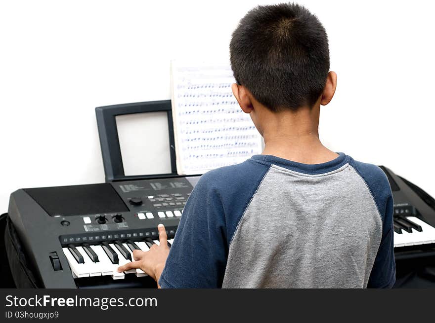 An handsome Indian kid doing his homework very happily