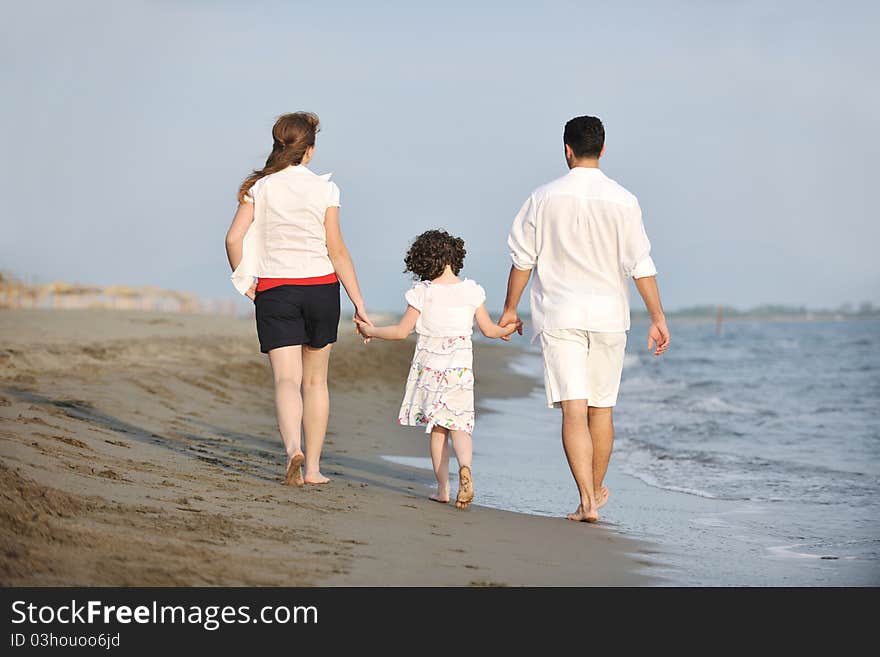 Happy young family have fun on beach