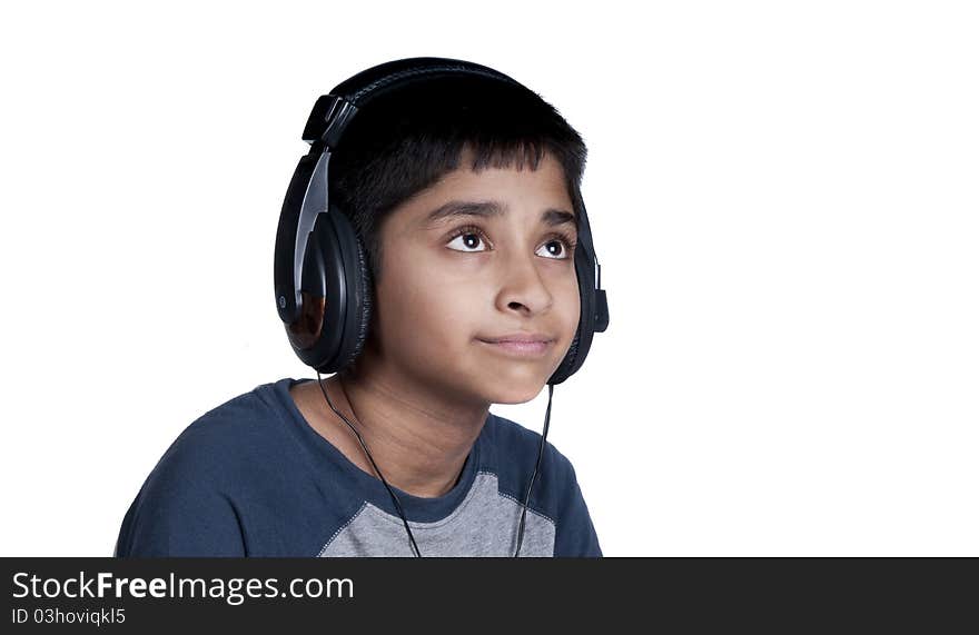 An handsome Indian kid enjoying music with lots of fun