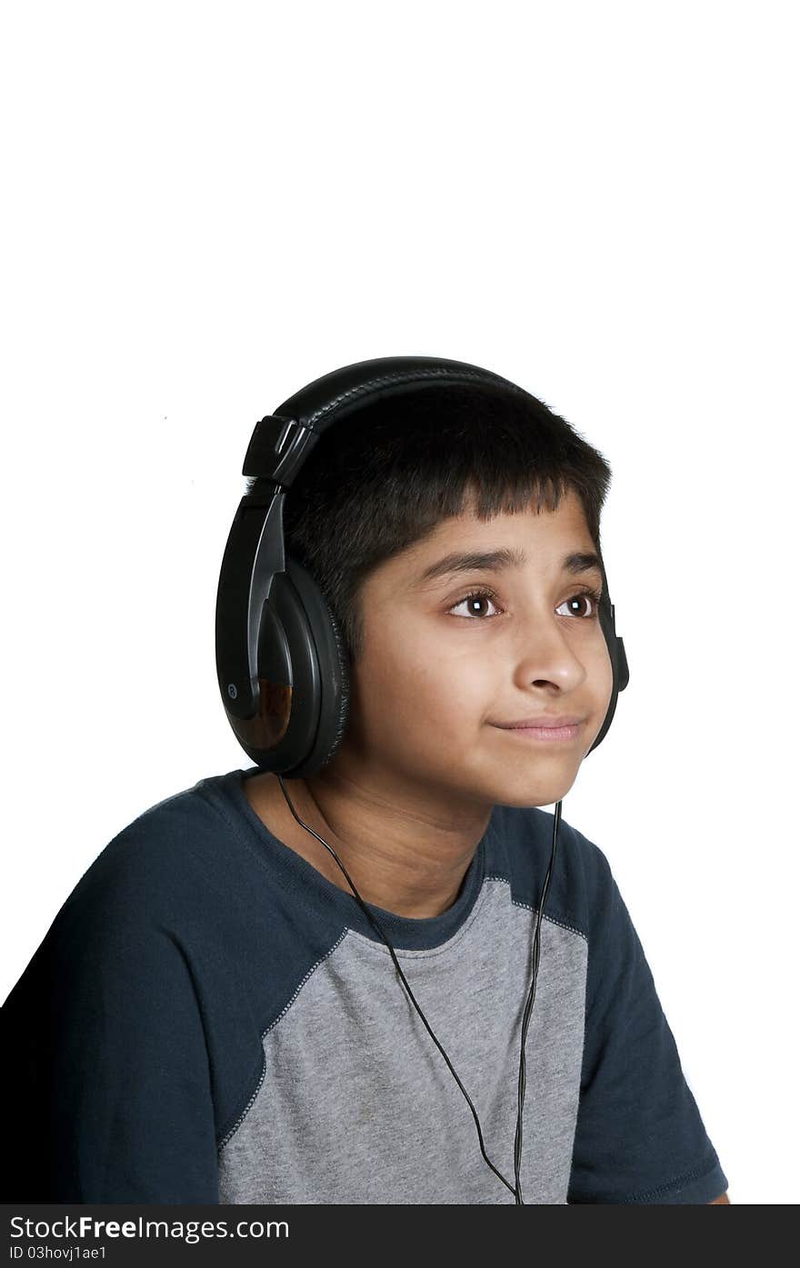 An handsome Indian kid enjoying music with lots of fun