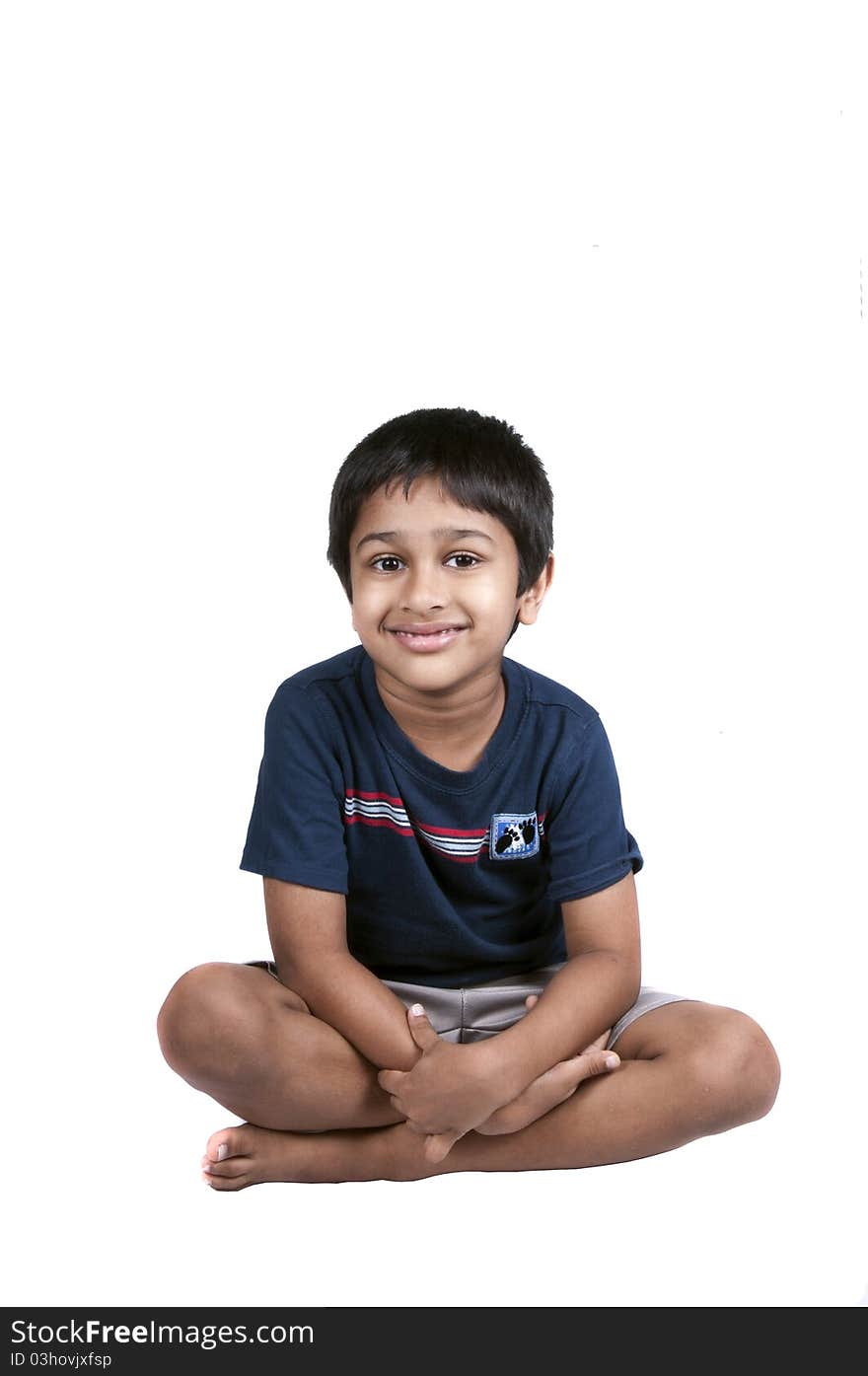 An handsome Indian kid sitting and smiling