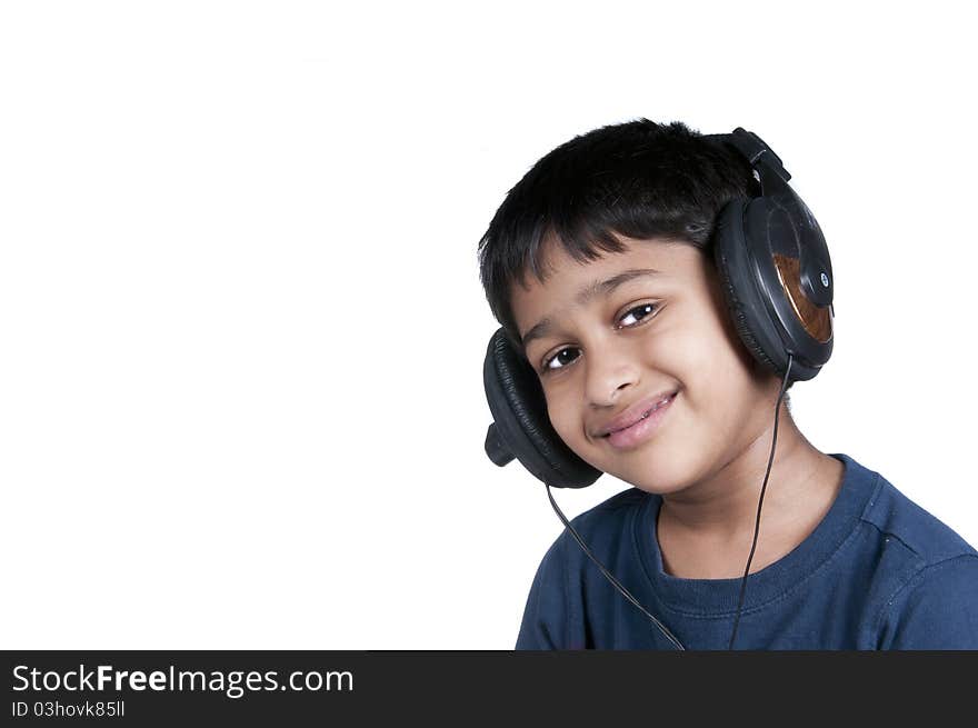 An handsome Indian kid enjoying music with lots of fun