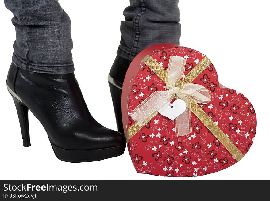 Woman holding a heart shaped box between her feet. Woman holding a heart shaped box between her feet