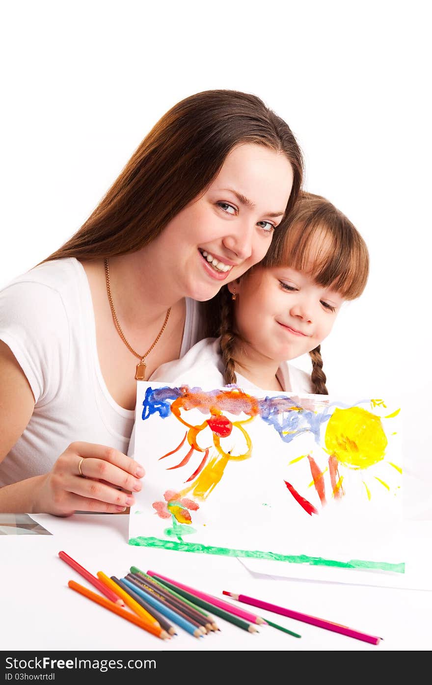 Young mother and her five year old daughter drawing with pencils and watercolor at home. Young mother and her five year old daughter drawing with pencils and watercolor at home