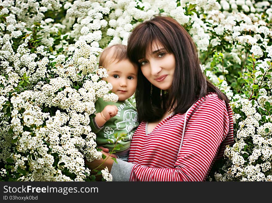 Woman and child among the flowering trees. Woman and child among the flowering trees