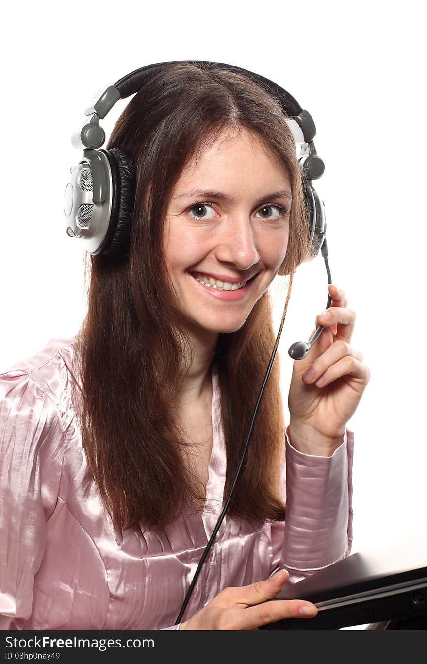 Attractive smiling young woman with headphones and laptop; isolated on white