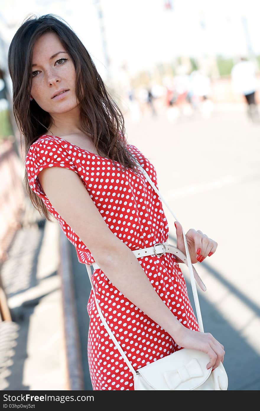 Beauty young woman on the bridge with unfocused people on background