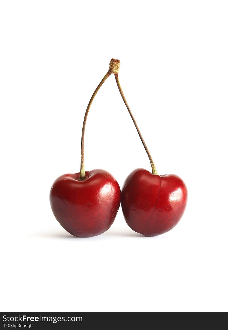 Two cherry berries with stem on white background. Clipping path is included. Two cherry berries with stem on white background. Clipping path is included