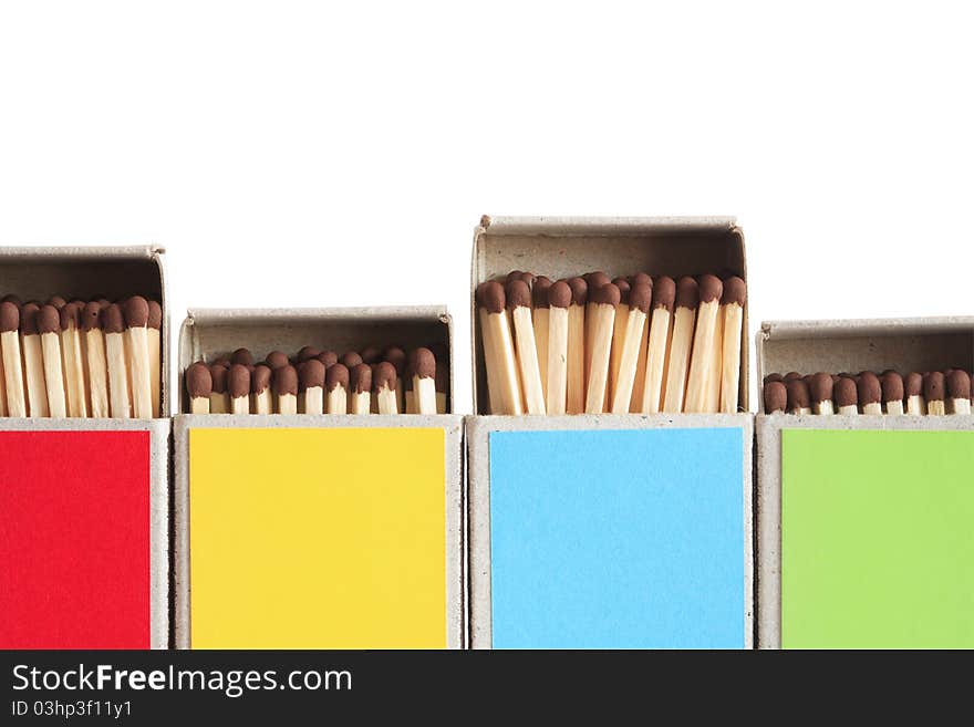 Closeup of few variegated matchboxes in a row on white background. Clipping path is included. Closeup of few variegated matchboxes in a row on white background. Clipping path is included