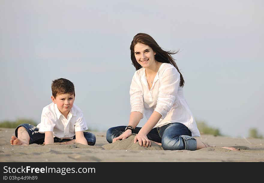 Mom and son relaxing on beach