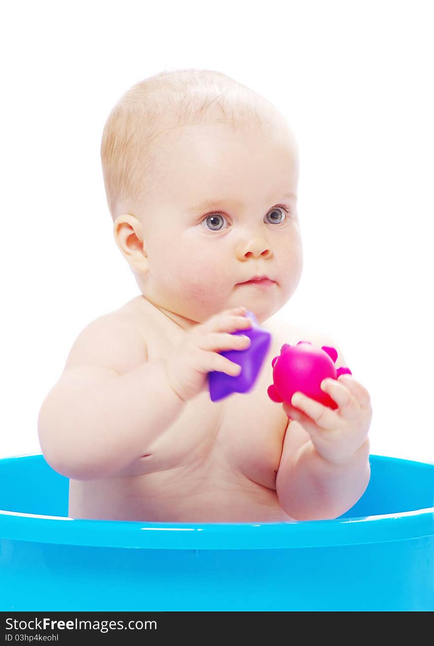 Baby sitting in a blue tub