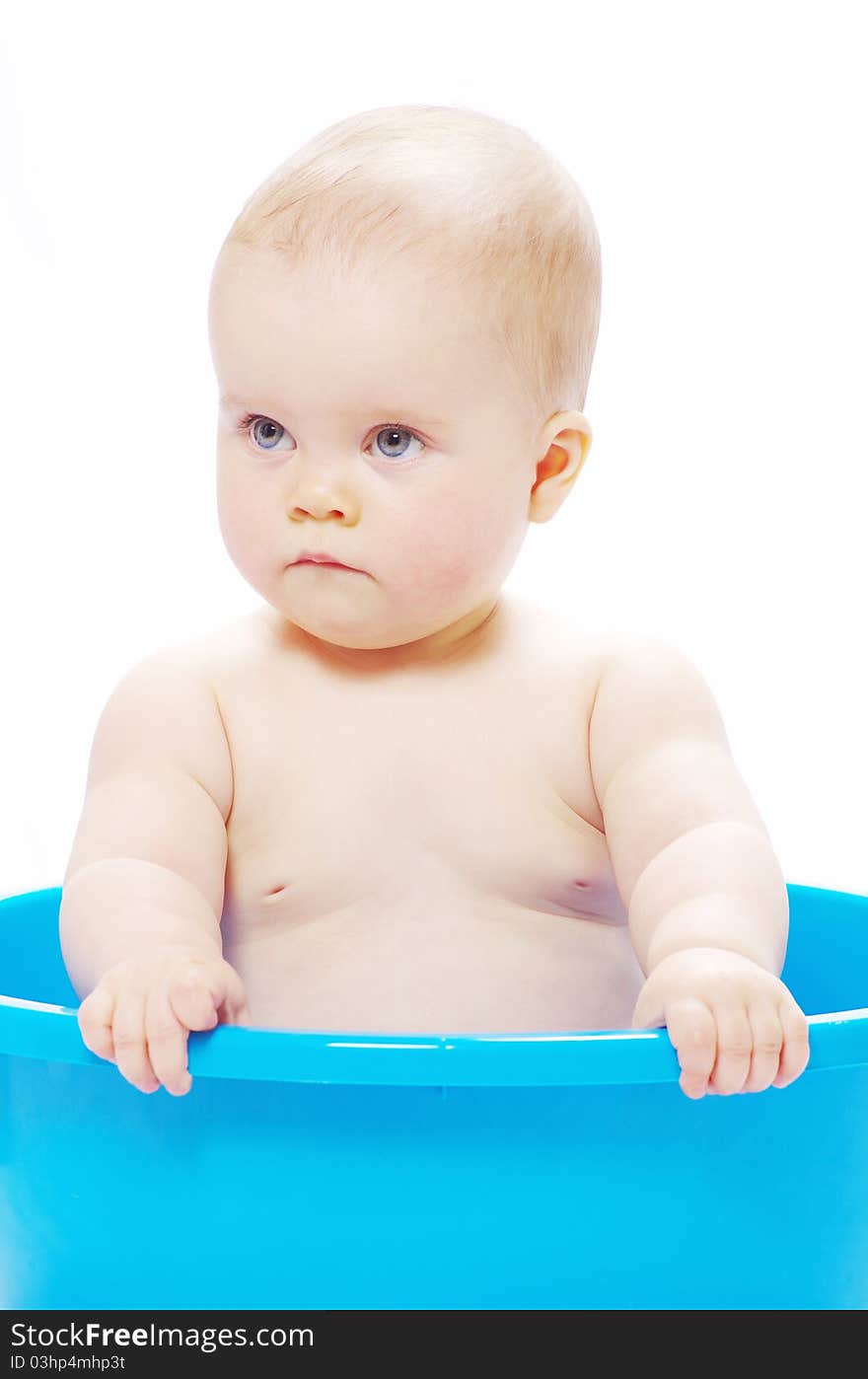 Baby sitting in a blue tub