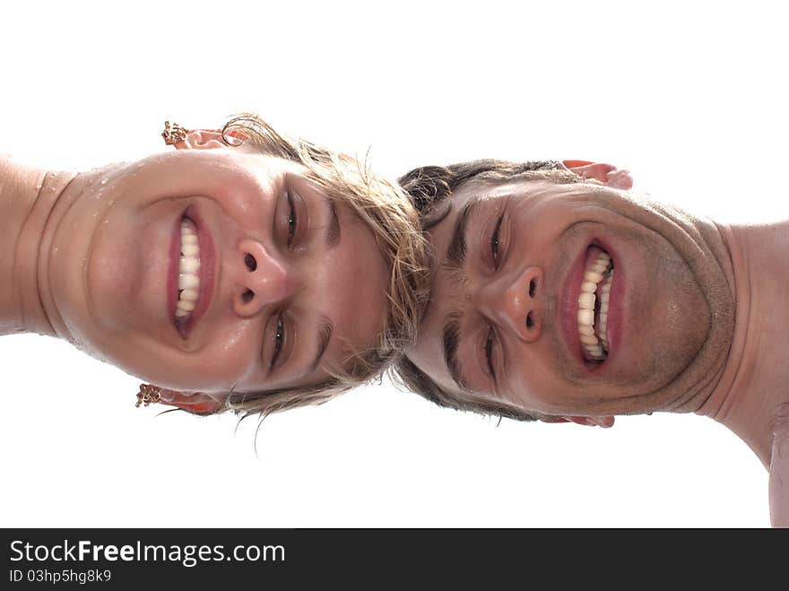 Young happy couple on the beach - closeup from underneath. Young happy couple on the beach - closeup from underneath