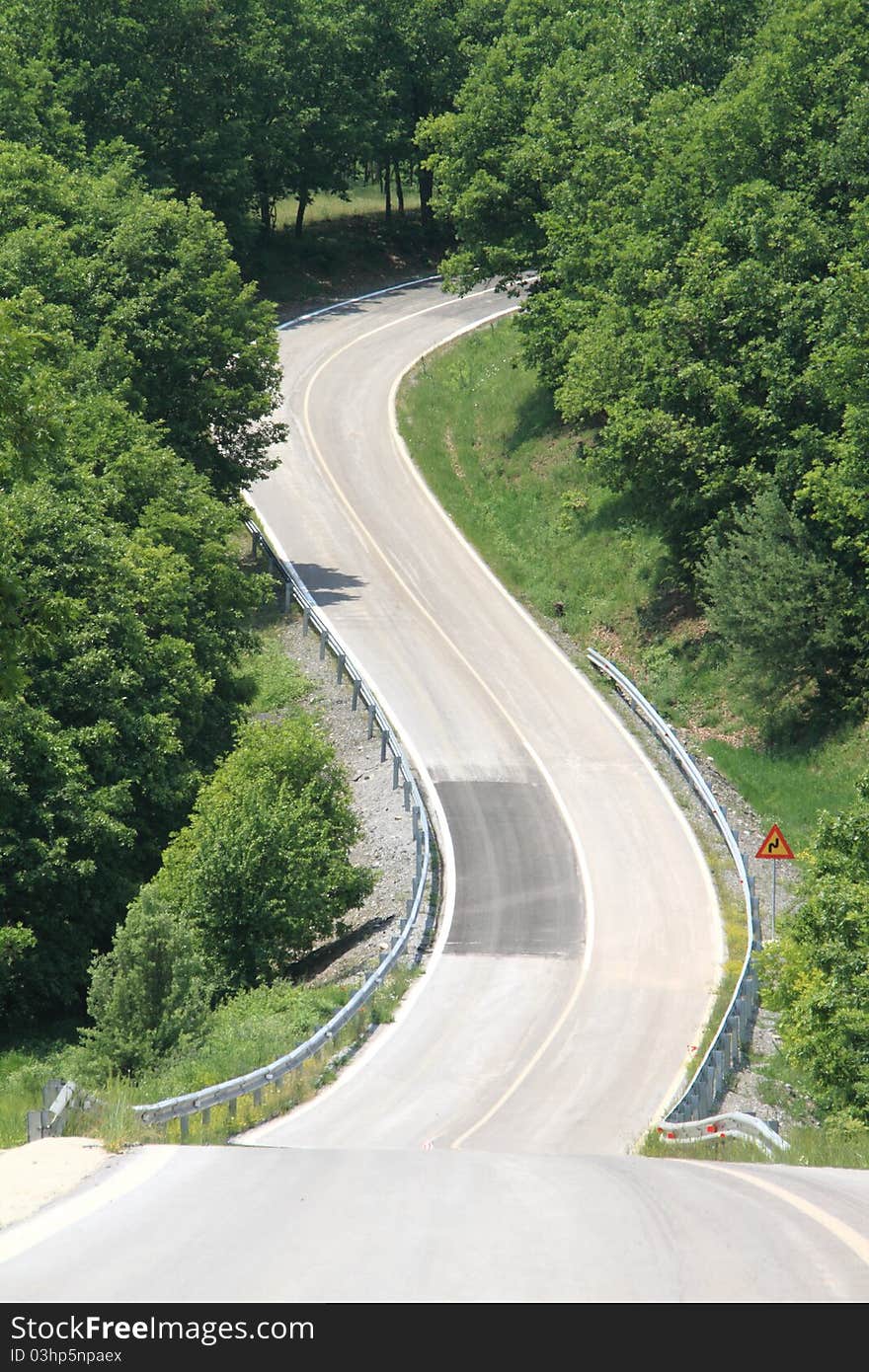 Winding country road through the trees