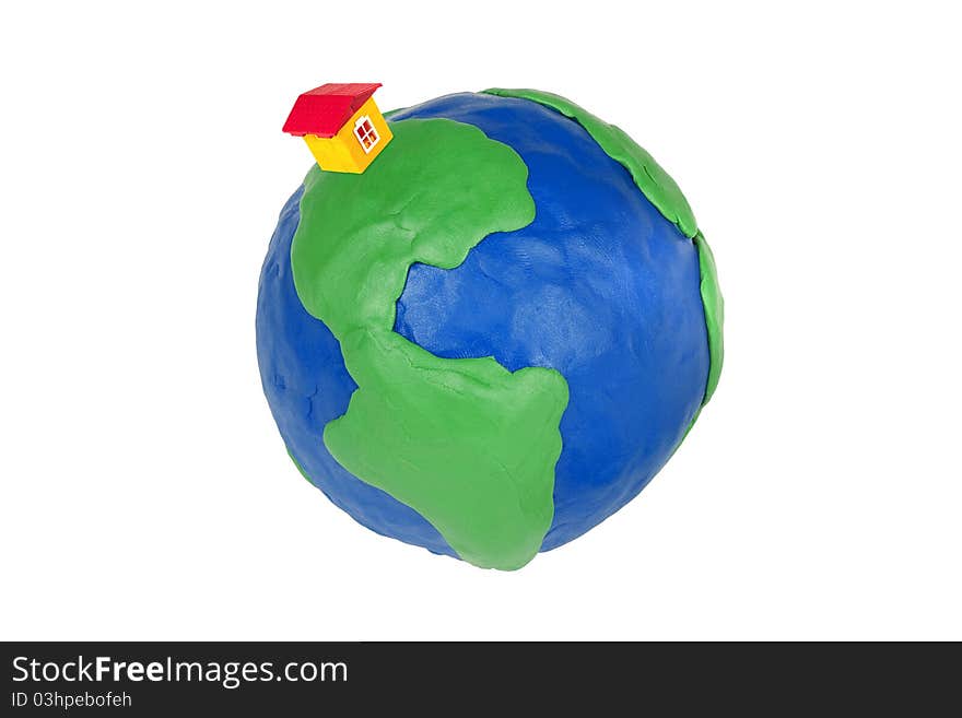 Plasticine globe and toy house on a white background. Plasticine globe and toy house on a white background