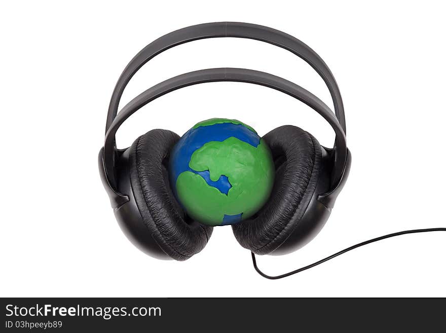 Headphones worn on plasticine globe on a white background. Headphones worn on plasticine globe on a white background