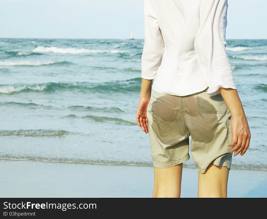 back view of young woman on the beach