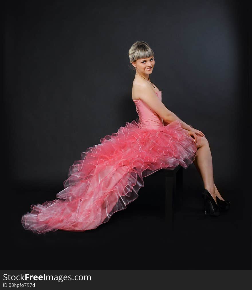 Portrait of the beauty young blond girl in the pink dress