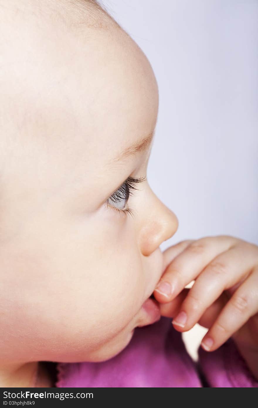 Baby side face portrait, studio shot. Baby side face portrait, studio shot