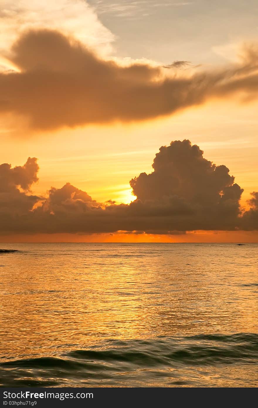 Bright sunrise in early morning with sand beach and ocean in summer