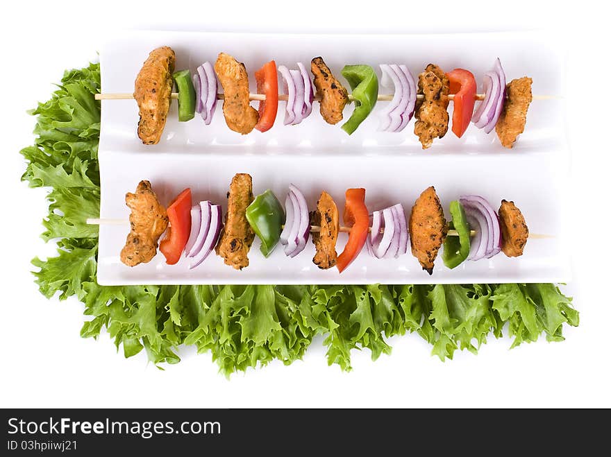 Skewers with chicken and vegetables on the plate - isolated. Skewers with chicken and vegetables on the plate - isolated