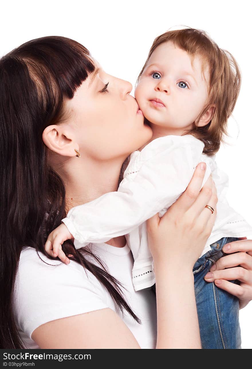 Happy family, young beautiful mother embracing and kissing her daughter, isolated against white background. Happy family, young beautiful mother embracing and kissing her daughter, isolated against white background