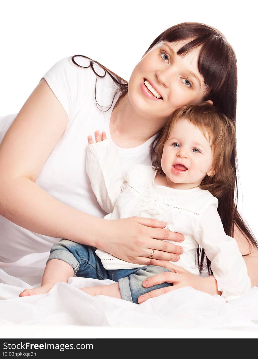 Happy family, young beautiful mother embracing and kissing her daughter. Happy family, young beautiful mother embracing and kissing her daughter