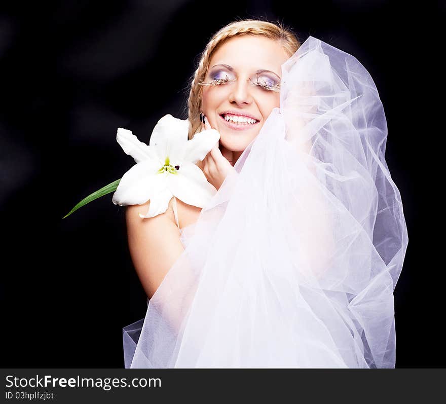 Beautiful young blond woman with a lily and creative makeup. Beautiful young blond woman with a lily and creative makeup