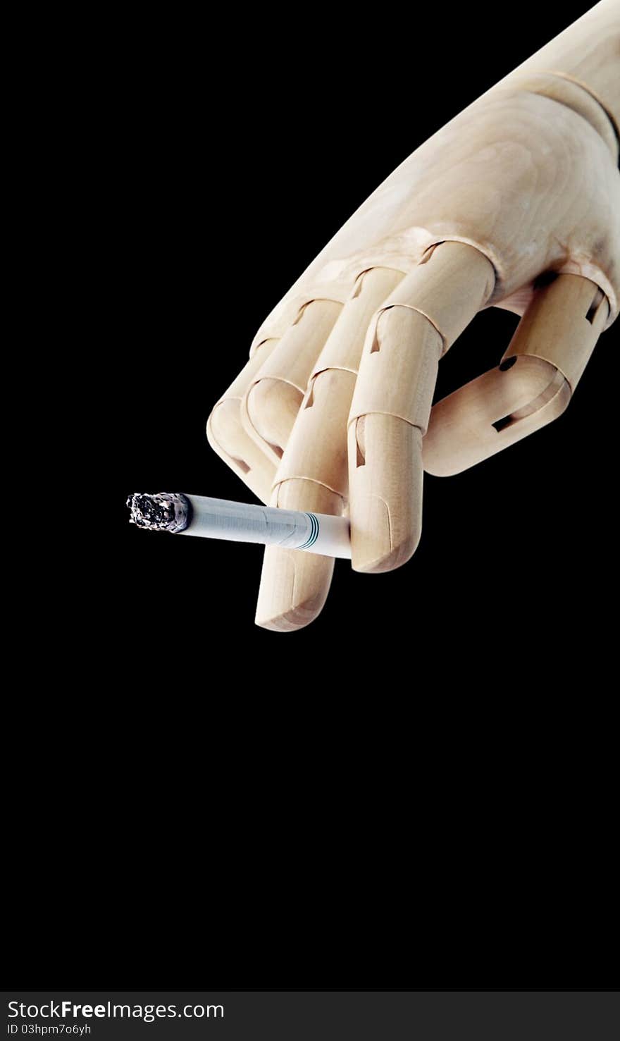 Wooden Hand with cigarette isolated on dark background