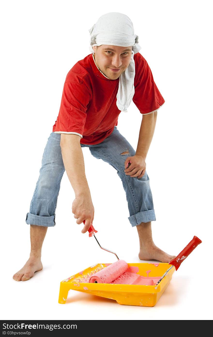 Cheerful young worker preparing to painting a wall