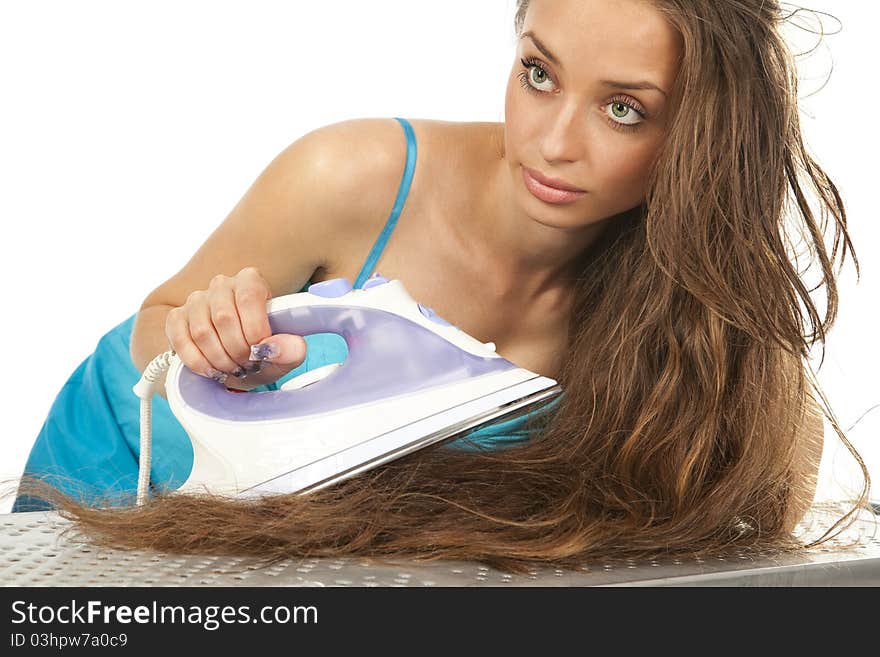 Woman ironing her hair